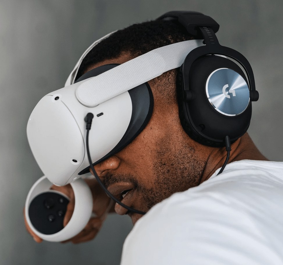 Person wearing headphones with a VR headset